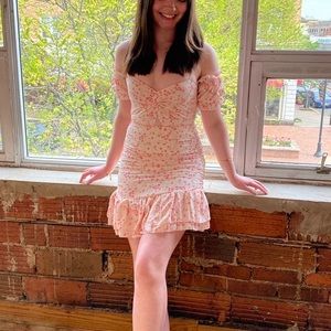 Light pink/baby pink floral mini dress with ruched ruffle hem and twist front